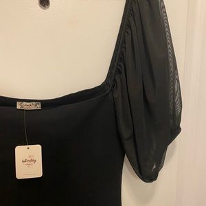 A black tight shirt with black puffy sleeves